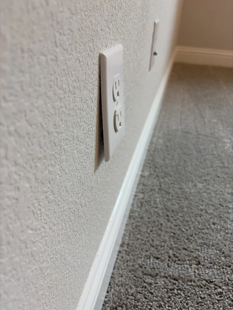 Electrical outlet cover plate not flush with the wall