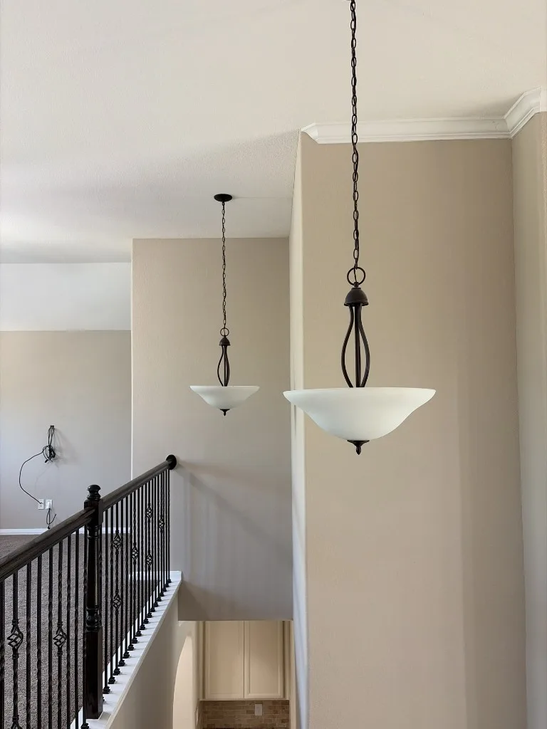 Pendant light fixtures hanging in a residential hallway