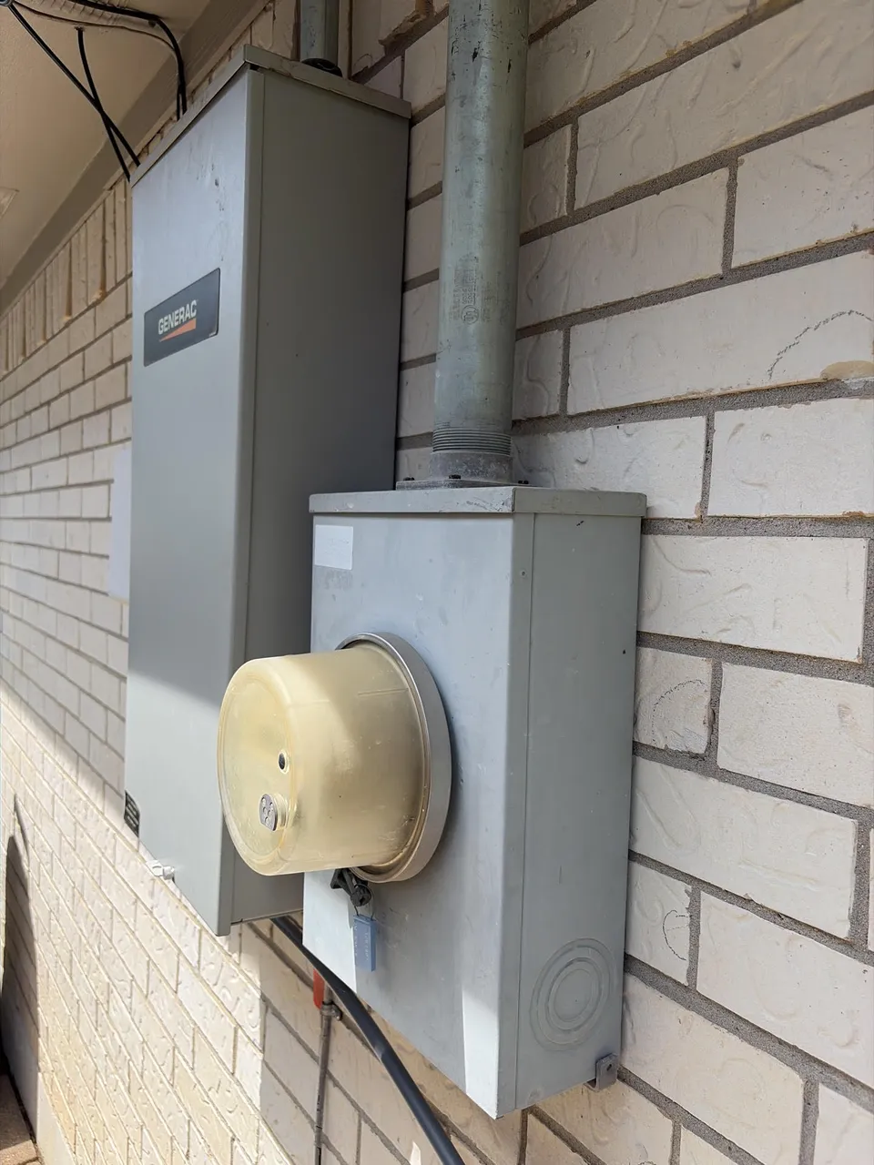 Generator and electrical meter mounted on an exterior wall