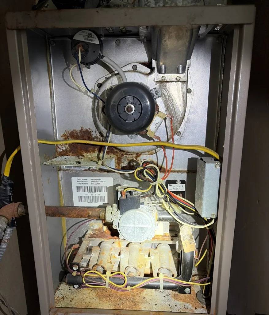 Interior of a gas furnace showing burners and controls