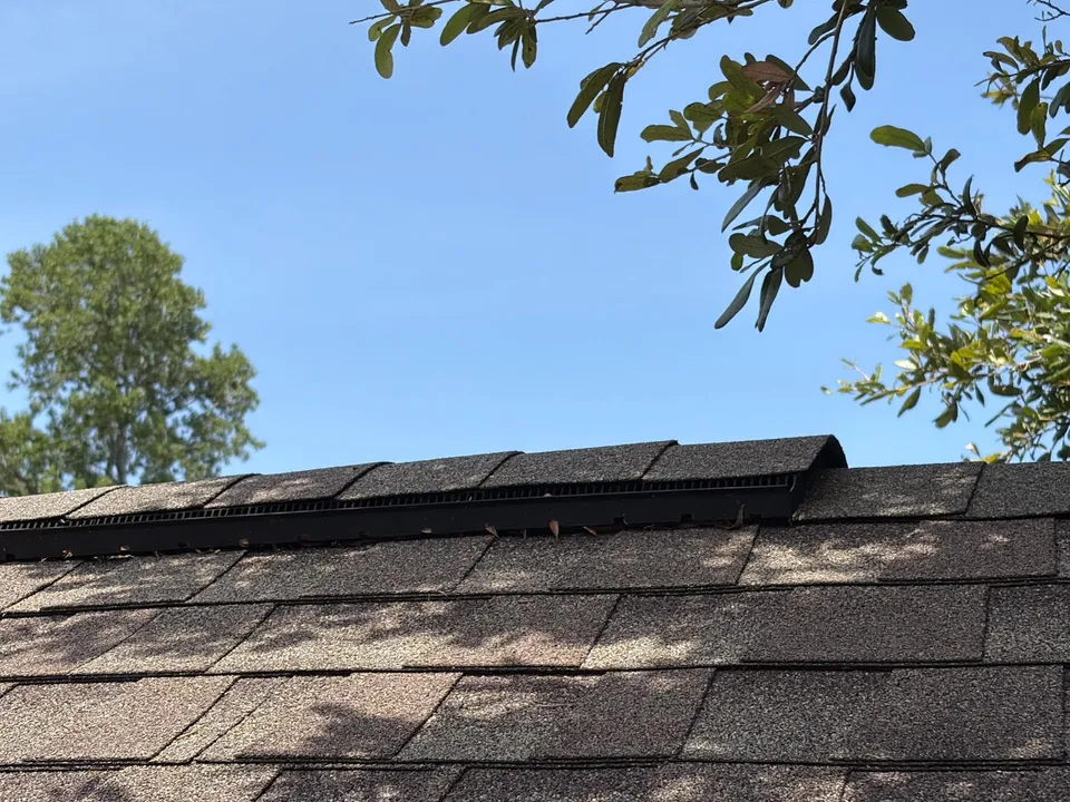 Ridge vent installed along a shingle roof peak