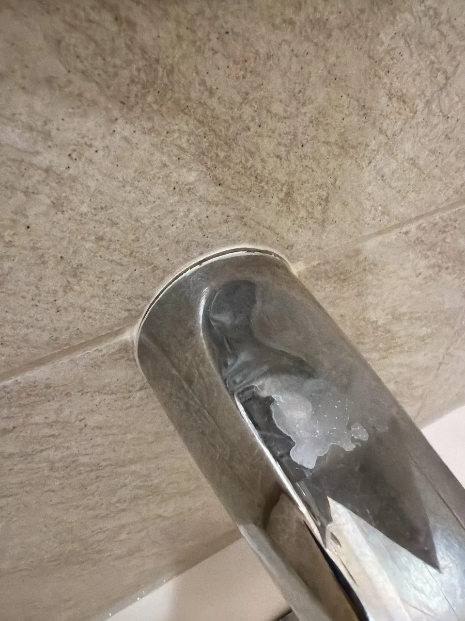 Mineral buildup around a tub spout escutcheon