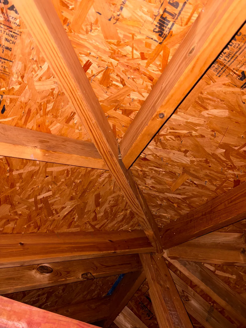 Wooden attic framing and roof sheathing