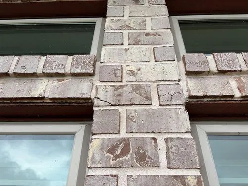 Cracked brick masonry on an exterior wall