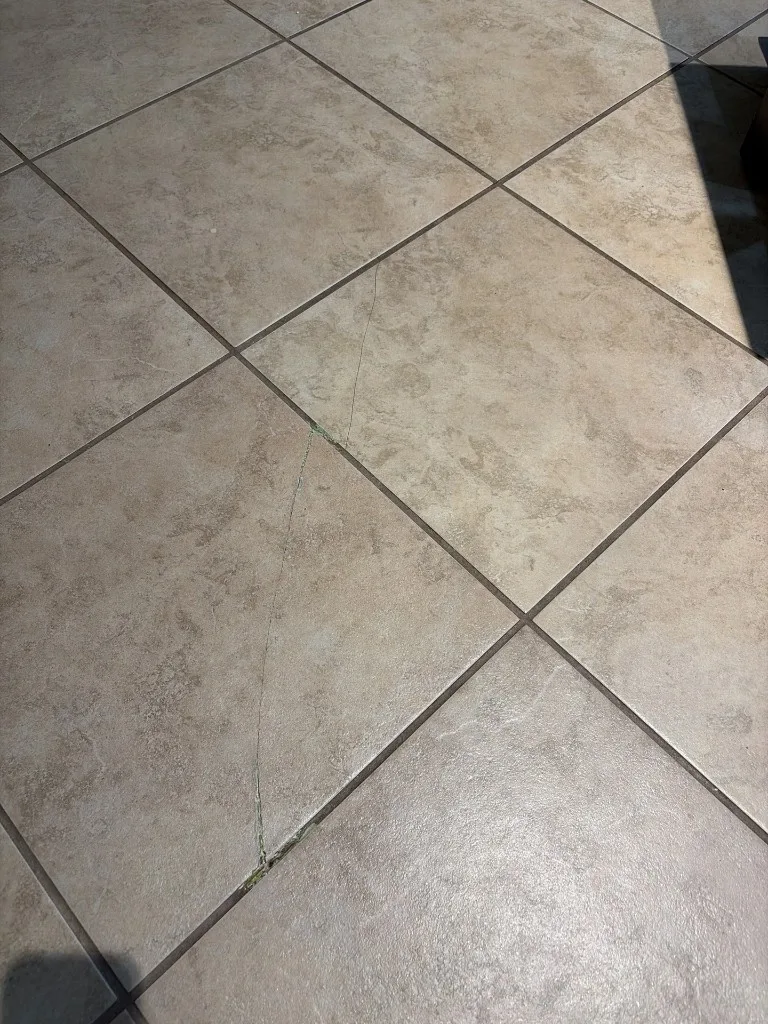 Crack running across tiled flooring